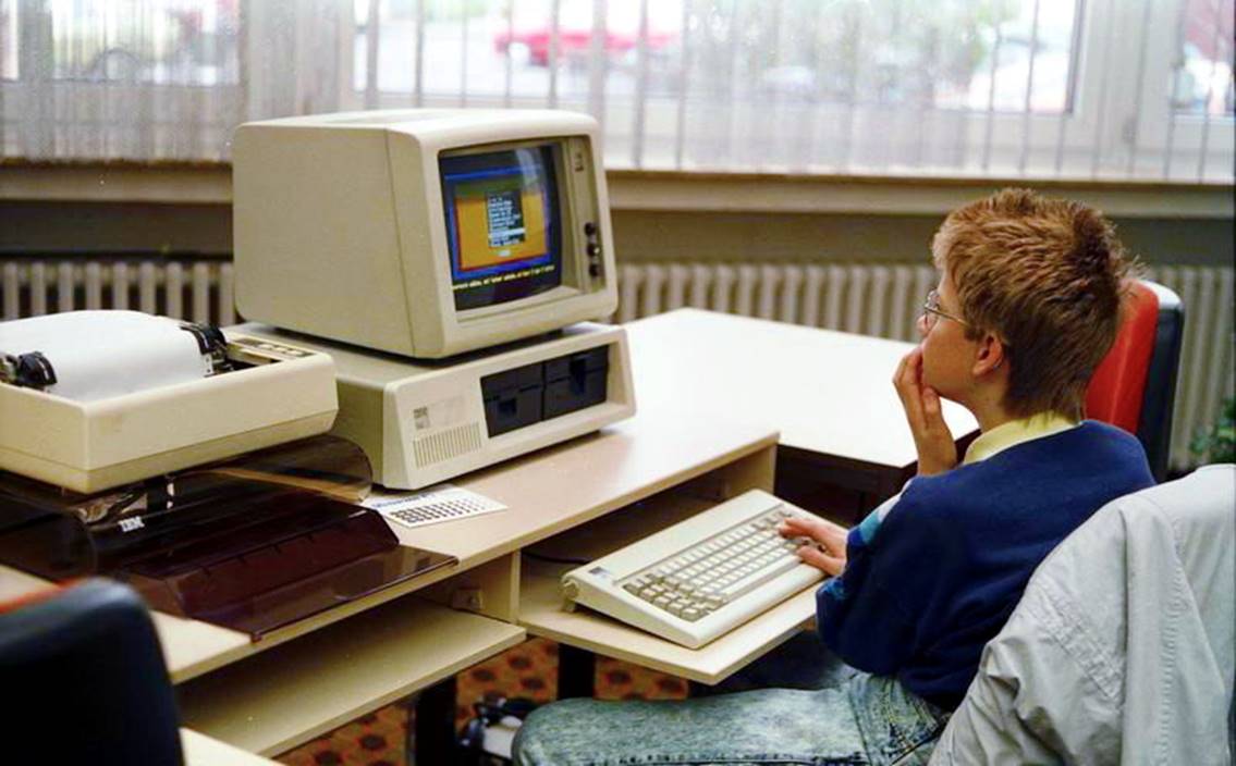 A boy using an IBM PC.